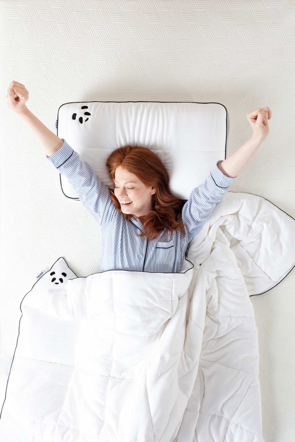 Happy girl laying on a Hybrid Bamboo Pillow with a bamboo cloud duvet